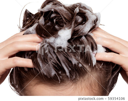 Woman soaping the hair. Beauty treatment 59354106
