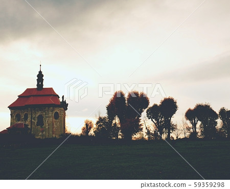 Chapel on hill with old lime trees alley. Dark 59359298