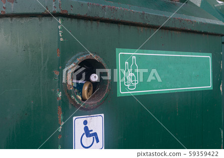 green iron recycling containers on the street closeup. iron dumpster for glas 59359422