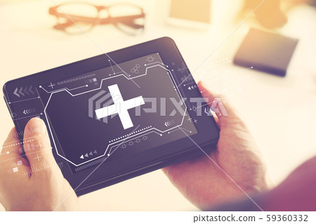Plus sign with a tablet computer 59360332