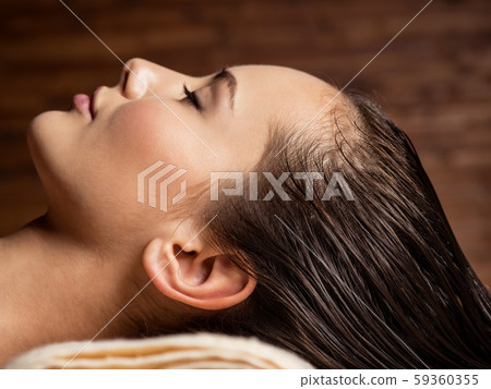 Woman receiving hair care procedure  in spa salon 59360355
