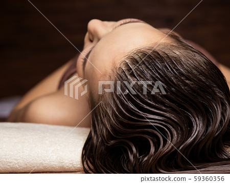 Woman receiving hair care procedure  in spa salon 59360356