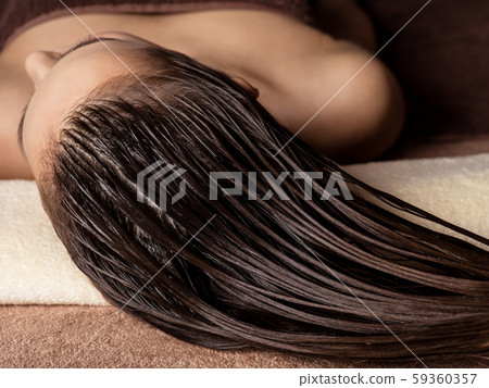 Woman receiving hair care procedure  in spa salon 59360357