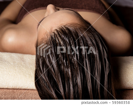 Woman receiving hair care procedure  in spa salon 59360358