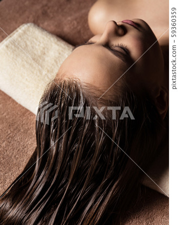 Woman receiving hair care procedure  in spa salon 59360359