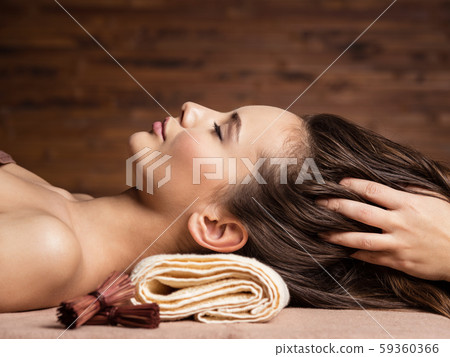 Masseur doing massage the head and hair for an 59360366