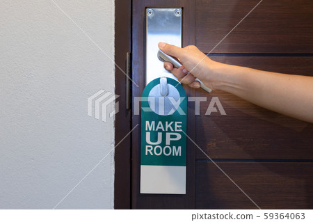 hand holding the door knob with label on a door hand holding the door knob with label on a door 59364063