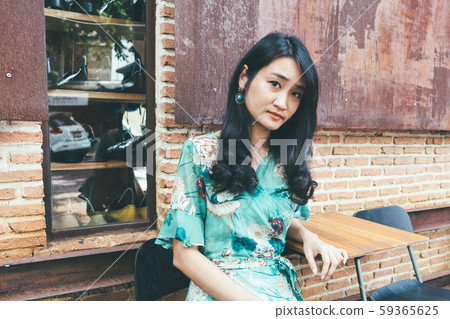 Beautiful Asian woman smiling in outdoor scene. Beautiful Asian woman smiling in outdoor scene. 59365625