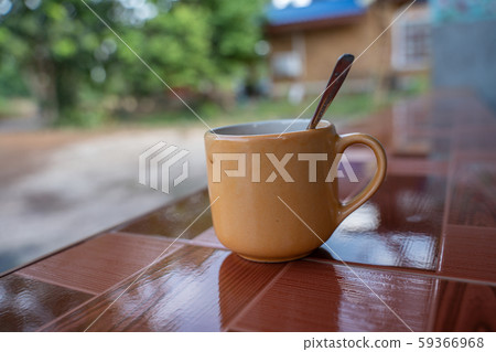 Cup of latte coffee in white cup on tile desk with Cup of latte coffee in white cup on tile desk with 59366968