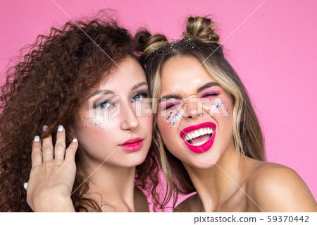 Beautiful and funny girls with bright makeup on a pink background. 59370442