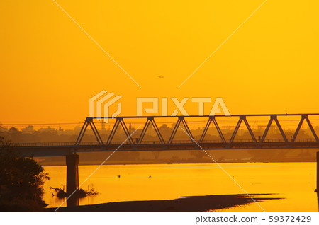 Sunrise and Keio Line Tamagawa Bridge viewed from Tamagawahara Bridge Sunrise and Keio Line Tamagawa Bridge viewed from Tamagawahara Bridge 59372429