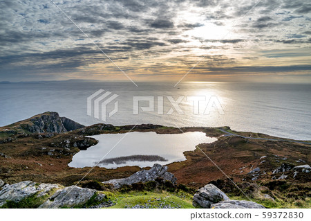 Sunset above the lake at Slieve League Cliffs which are among the highest sea cliffs in Europe 59372830