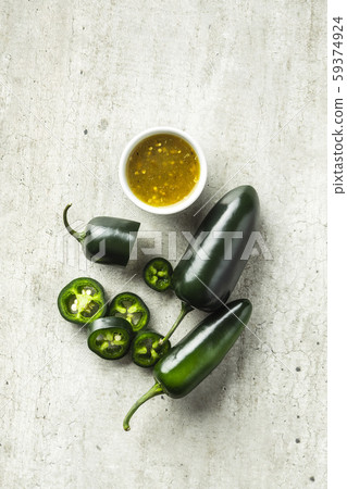 Green jalapeno pepper and tabasco sauce. Green jalapeno pepper and tabasco sauce. 59374924