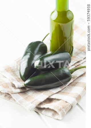 Green jalapeno pepper and tabasco sauce. Green jalapeno pepper and tabasco sauce. 59374938