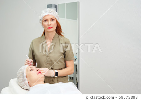 doctor uses syringe with collagen to do medical treatment doctor uses syringe with collagen to do medical treatment 59375898