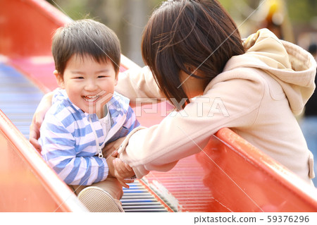 Parents and children playing on the slide Parents and children playing on the slide 59376296