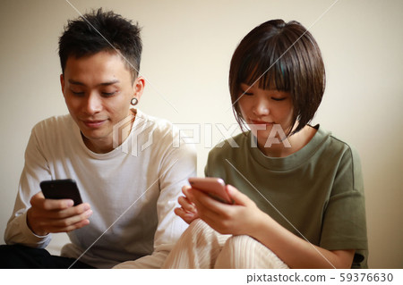 Couple using a smartphone Couple using a smartphone 59376630