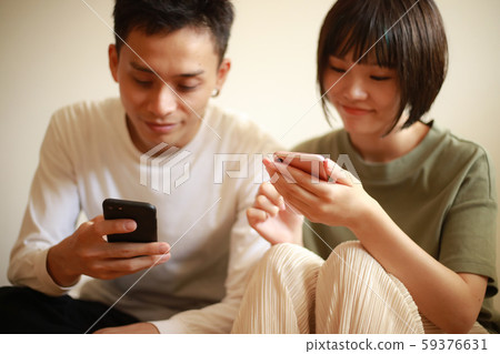 Couple using a smartphone Couple using a smartphone 59376631