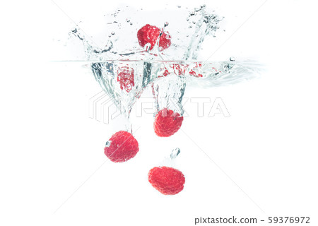 Bunch of raspberries splashing into water surface Bunch of raspberries splashing into water surface 59376972