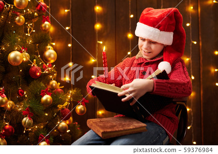 Teen boy reading book, sitting indoor near Teen boy reading book, sitting indoor near 59376984