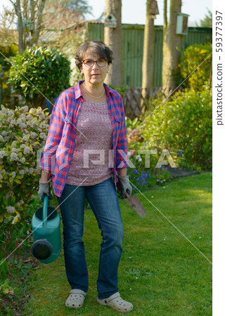 woman gardening in her beautiful garden. woman gardening in her beautiful garden. 59377397