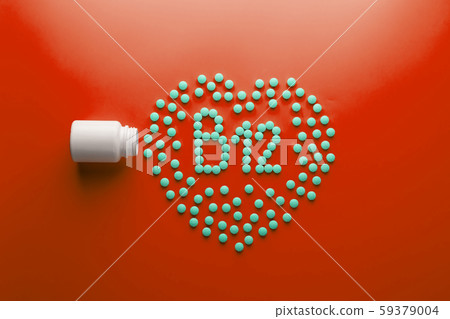 Vitamins B 12 in the shape of a heart on a red 59379004