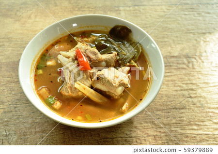 hot and spicy pork bone with tamarind and Thai herbs soup on bowl  59379889