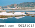 Workers gathering sea salt from harvesting sea salt in Ninh Thuan, Vietnam. Farmers harvest salt. Royalty high quality stock image of landscape. Workers gathering sea salt from harvesting sea salt in Ninh Thuan, Vietnam. Farmers harvest salt. Royalty high quality stock image of landscape. 59381012