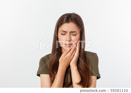 Teen woman pressing her bruised cheek with a painful expression as if she is having a terrible tooth 59381110