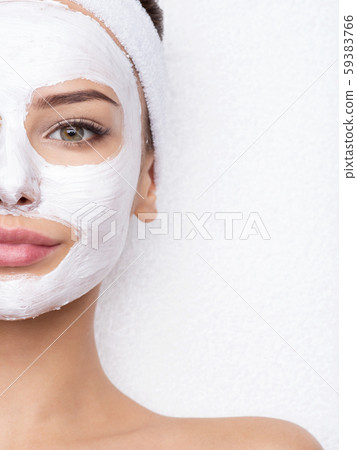 woman relaxing in spa salon with cosmetic mask on 59383766