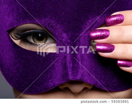 Woman with purple nails and violet theatre mask on 59383891