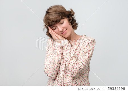 Young woman with her eyes closed having positive thoughts Young woman with her eyes closed having positive thoughts 59384696