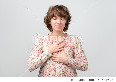 Young woman with her eyes closed having positive thoughts Young woman with her eyes closed having positive thoughts 59384698