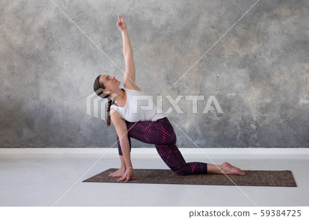 doing exercise for spine flexibility, standing in parivritta parshvakonasana 59384725