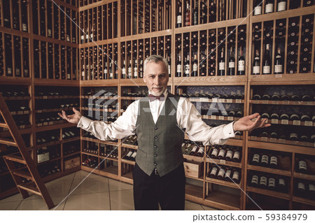 Sommelier Concept. Senior man standing hands aside welcoming smiling friendly 59384979