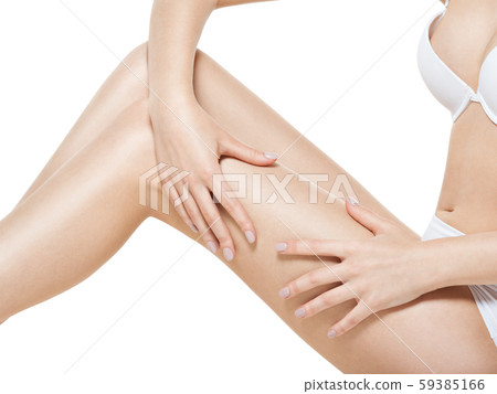 Woman squeezes cellulite skin on  leg 59385166