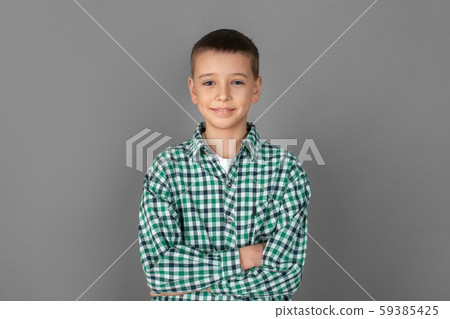 Freestyle. Boy standing isolated on grey wall crossed arms smiling happy Freestyle. Boy standing isolated on grey wall crossed arms smiling happy 59385425