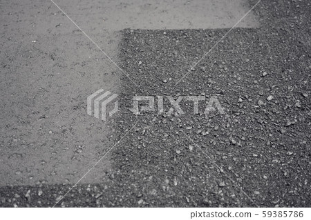 Closeup new hot asphalt. Laying asphalt, covering the pit, on the rubble. Asphalt Compactors is Closeup new hot asphalt. Laying asphalt, covering the pit, on the rubble. Asphalt Compactors is 59385786