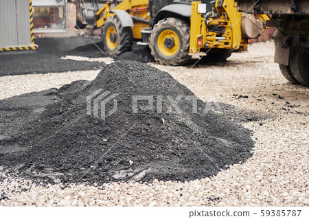 Heap new hot asphalt. Laying asphalt, covering the pit, on the rubble. Asphalt Compactors is Heap new hot asphalt. Laying asphalt, covering the pit, on the rubble. Asphalt Compactors is 59385787