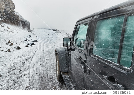 Car on Icelandic snowy terrain 59386081