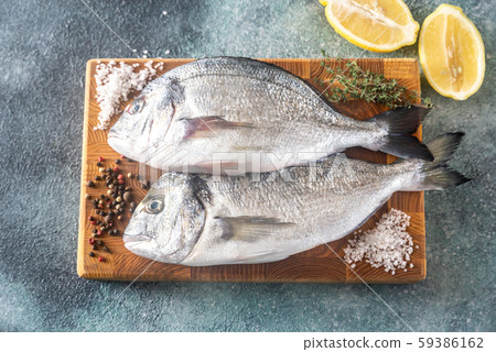 Fresh dorada on the wooden board Fresh dorada on the wooden board 59386162