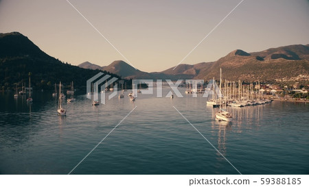 Low altitude aerial view of anchored sailing boats near coastal town of Nydri. Lefkada, Greece 59388185