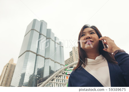woman walking outdoor and talking on mobile phone 59389675