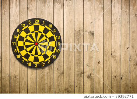 dartboard on brown wooden plank wall background 59392771