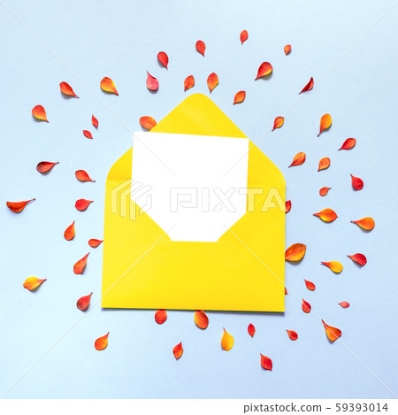 Envelope of orange color inside which is a blank white sheet of paper. 59393014