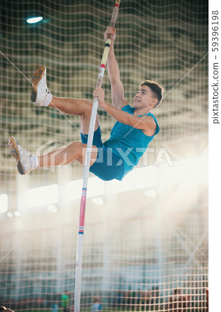 Pole vaulting - man is holding the pole by his hands Pole vaulting - man is holding the pole by his hands 59396198