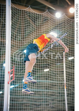 Pole vaulting - man is falling after jump with pole Pole vaulting - man is falling after jump with pole 59396200