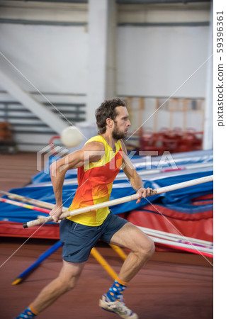 Pole vaulting - man is running with pole in hands Pole vaulting - man is running with pole in hands 59396361