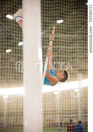 Pole vaulting training - young fit man jumping over the bar Pole vaulting training - young fit man jumping over the bar 59396551