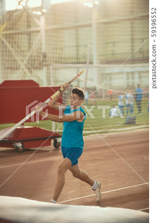 Pole vaulting training - young fit man about to jump 59396552